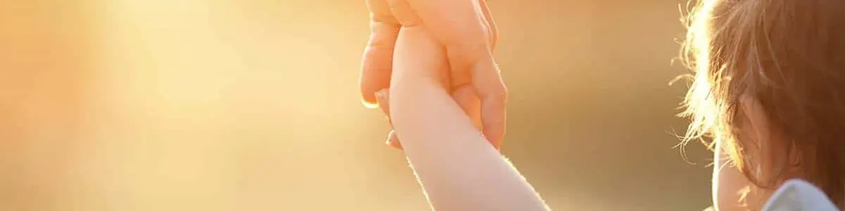 Mother holding child's hand
