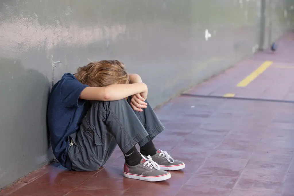 boy outside alone